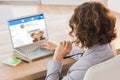 Composite image of businesswoman using laptop at desk in creative office Royalty Free Stock Photo