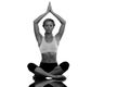 Composite image of calm blonde meditating in lotus pose with arms raised Royalty Free Stock Photo