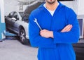 Composite image of car mechanic holding wrench