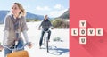 Composite image of carefree couple going on a bike ride on the beach Royalty Free Stock Photo