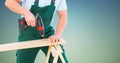 Composite image of Carpenter drilling against blue green background Royalty Free Stock Photo