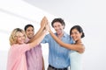 Composite image of casual business team high fiving Royalty Free Stock Photo