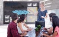 Composite image of casual businesswoman giving presentation to her colleagues Royalty Free Stock Photo