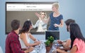 Composite image of casual businesswoman giving presentation to her colleagues Royalty Free Stock Photo