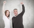 Composite image of casual couple cheering at camera