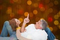 Composite image of casual couple lying on floor Royalty Free Stock Photo