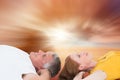 Composite image of casual couple lying on floor Royalty Free Stock Photo