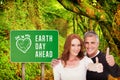 Composite image of casual couple showing thumbs up Royalty Free Stock Photo