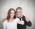 Composite image of casual couple showing thumbs up Royalty Free Stock Photo