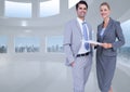 Composite image of caucasian businessman and businesswoman smiling against office interior Royalty Free Stock Photo