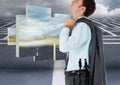 Composite image of caucasian businessman looking up against road and maze in background