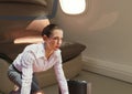 Composite image of caucasian businesswoman with a suitcase against airplane window in background