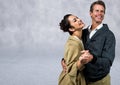 Composite image of caucasian couple dancing and smiling against textured grey background Royalty Free Stock Photo