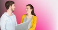 Composite image of caucasian couple using laptop against copy space on pink gradient background Royalty Free Stock Photo