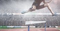 Composite image of caucasian low section of male athlete jumping over hurdles against sports stadium