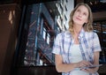 Composite image of caucasian woman using digital tablet against tall buildings
