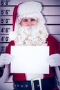 Composite image of cheerful santa claus holding page Royalty Free Stock Photo