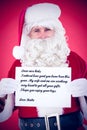 Composite image of cheerful santa claus holding page Royalty Free Stock Photo