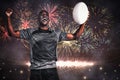 Composite image of cheerful sportsman with clenched fist holding rugby ball Royalty Free Stock Photo