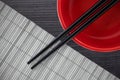 Composite image of close up of black chopstick with bowl Royalty Free Stock Photo