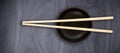 Composite image of close up of chopstick on black bowl Royalty Free Stock Photo