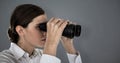 Composite image of close up of confident businesswoman looking through binoculars Royalty Free Stock Photo