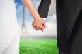 Composite image of close up of cute young newlyweds holding their hands Royalty Free Stock Photo