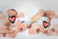 Composite image of close up of the feet of a family