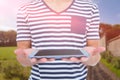 Composite image of close up of man holding tablet against rural landscape Royalty Free Stock Photo