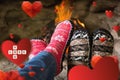 Composite image of close up of romantic legs in socks in front of fireplace Royalty Free Stock Photo