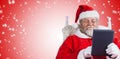 Composite image of close-up of santa claus holding digital tablet on armchair Royalty Free Stock Photo