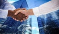 Composite image of close-up shot of a handshake in office Royalty Free Stock Photo