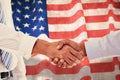 Composite image of close-up shot of a handshake in office Royalty Free Stock Photo