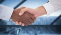 Composite image of close-up shot of a handshake in office Royalty Free Stock Photo