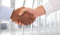 Composite image of close-up shot of a handshake in office Royalty Free Stock Photo