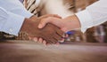 Composite image of close-up shot of a handshake in office Royalty Free Stock Photo