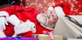 Composite image of close-up of tired santa claus sleeping beside christmas presents Royalty Free Stock Photo