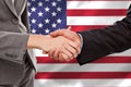 Composite image of close up of two businesspeople shaking their hands Royalty Free Stock Photo