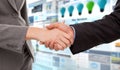 Composite image of close up of two businesspeople shaking their hands Royalty Free Stock Photo