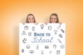 Composite image of close up of young women behind a blank sign