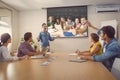 Composite image of college students gesturing thumbs up in library Royalty Free Stock Photo