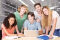 Composite image of college students using laptop in library Royalty Free Stock Photo