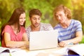 Composite image of college students using laptop in library Royalty Free Stock Photo