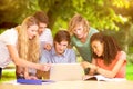 Composite image of college students using laptop in library Royalty Free Stock Photo