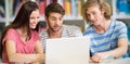 Composite image of college students using laptop in library Royalty Free Stock Photo