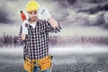 Composite image of confident handyman holding drill machine Royalty Free Stock Photo