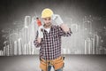 Composite image of confident handyman holding drill machine Royalty Free Stock Photo