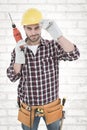 Composite image of confident handyman holding drill machine Royalty Free Stock Photo