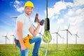 Composite image of confident handyman holding power drill while climbing ladder Royalty Free Stock Photo