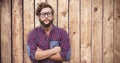 Composite image of confident hipster wearing eye glasses with arms crossed